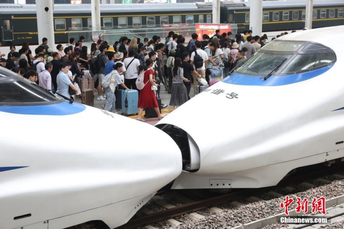 9月30日，江苏南京，旅客们在火车站出行。当日，长三角铁路迎来国庆黄金周节前出行大客流，预计发送旅客338万人次，对客流饱满方向增开467列旅客列车满足高峰客流出行需要。今年国庆黄金周运输期限自9月29日起至10月8日止，共计10天。中新社记者 泱波 摄